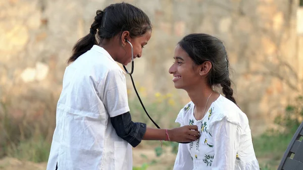 Indian kid doctor of pediatrician holding stethoscope checking heartbeat of sick boy kid. health checkup, children medical insurance care. healthcare Concept