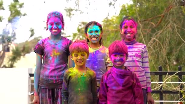 快乐的印地安人孩子们玩着五颜六色的游戏 在亚洲孩子们的脸上挂着五颜六色的笑容庆祝霍利 印度音乐节的概念 聪明的孩子涂上了彩粉 — 图库视频影像