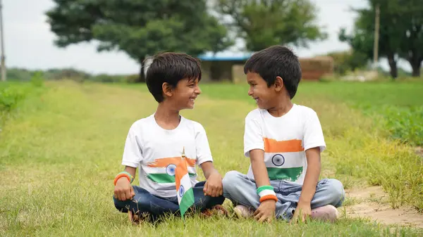 stock image Handsome cute little Indian boy or kid in white ethnic wear standing infant of indian national flag and showing patriotism. Har Ghar Tiranga