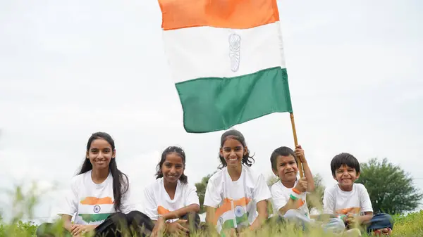 stock image Group of happy Indian wearing traditional white dress holding indian flag celebrating Independence day or Republic day. Har Ghar Tiranga