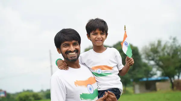 stock image Cute Little smiling boy with his father with indian flag. Celebrating Independnce day or Republic day.. Har Ghar Tiranga