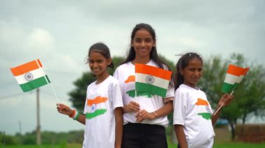 Bir grup öğrenci ya da üç renkli Hint tişörtü giyen bir grup çocuk, yüzü üç renkli renklerle boyanmış ve selam veriyor. Bağımsızlık ya da Cumhuriyet Günü 'nü kutluyoruz. Har Ghar Tiranga