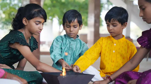 Geleneksel kıyafetli bir Hintli aile, evlerinde enerjilerini dengelemek için bir rahip tarafından yönetilen Yagya veya Havan 'ı icra eder. Bu kutsal pooja uyum ve pozitif enerji içindir..