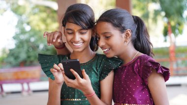 Genç kız cep telefonu kullanıyor sosyal medyada mesajlaşmalar paylaşıyor, yeni video bloğunun keyfini çıkarıyor, internetin işe ara vermesini dizüstü bilgisayarla izliyor. Teknoloji, e-servis, mobil uygulama kullanımı kavramı