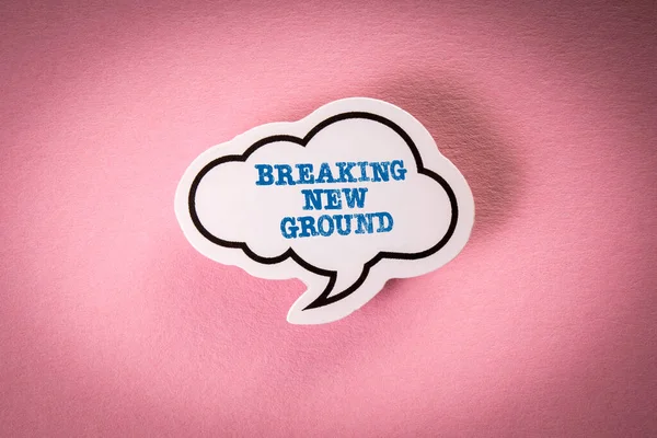 Breaking new ground. Text on white speech bubble. Pink background.