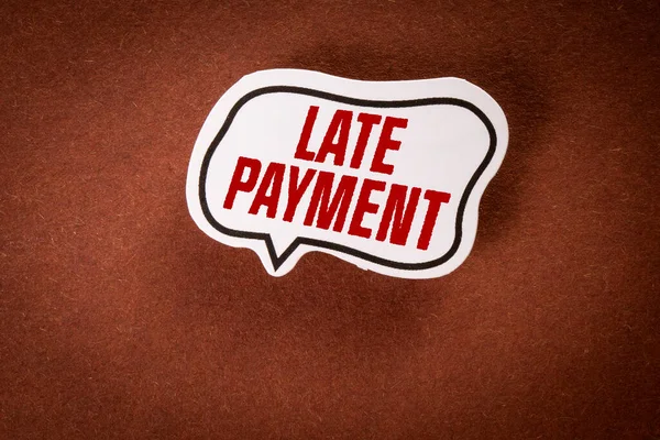 LATE PAYMENT concept. Speech bubble with text on brown background.