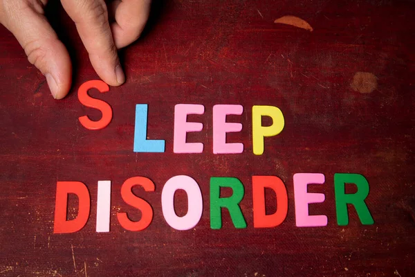 SLEEP DISORDER. Text from colorful alphabet letters on wooden background.