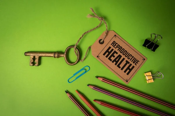 Reproductive Health Concept. Key with price tag on green background.