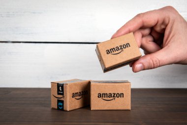 Sigulda, Latvia - February 5, 2023: Amazon Prime miniature cardboard boxe in a womans hand.