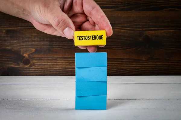 Testosterone Concept. Colorful blocks on a painted wooden background.