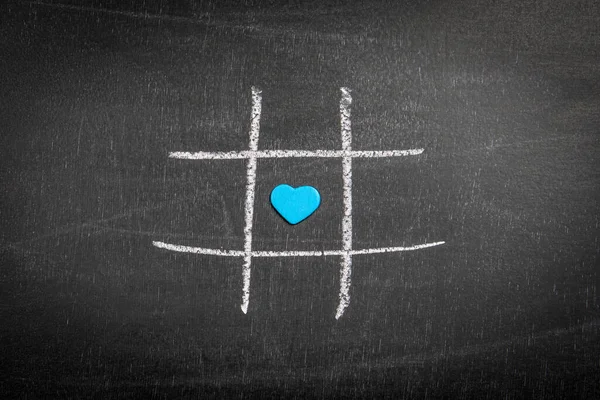 Blue heart on the chalk board. Game of tic tac. Abstract LGBT background.