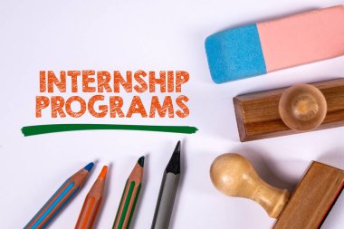 Internship Programs. Colored pencils, stamps and eraser on a white background. clipart