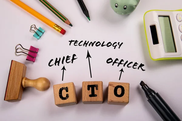 CTO - Chief Technology Officer. Wooden blocks on a white office table.