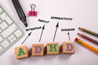 ADHD - Attention Deficit Hyperactivity Disorder. Wooden blocks on a white office table. clipart