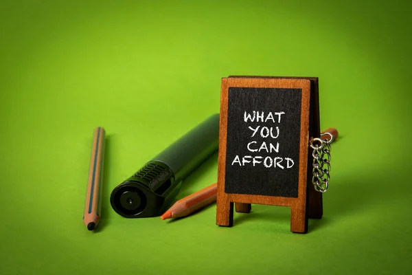 What You Can Afford Miniature Chalkboard Text Green Background — Stock Photo, Image
