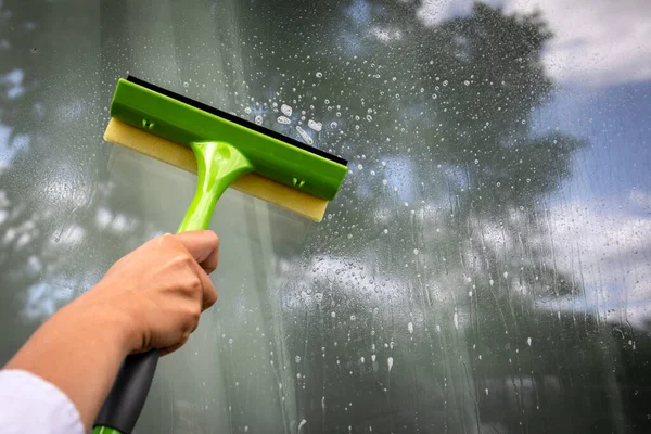 Window cleaning brush for windows washing. The exterior of the house.