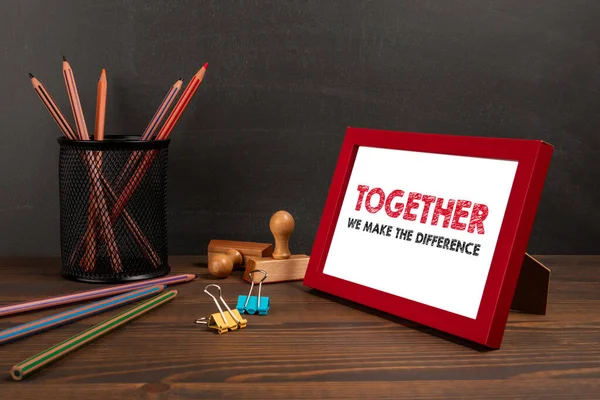 TOGETHER WE MAKE THE DIFFERENCE. A picture frame on the office table.