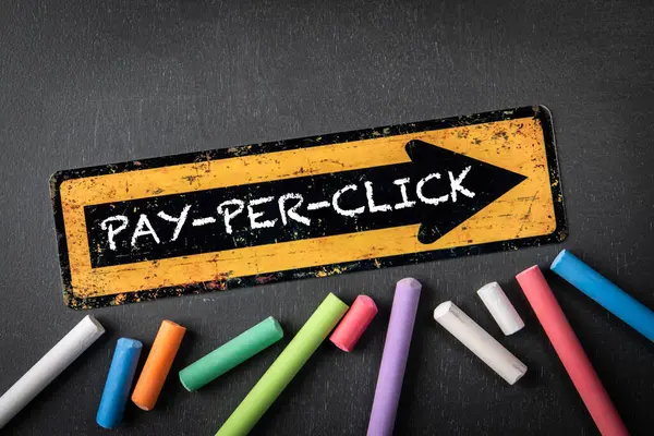 Pay Per Click Concept. yellow directional arrow with text on a dark chalkboard background.
