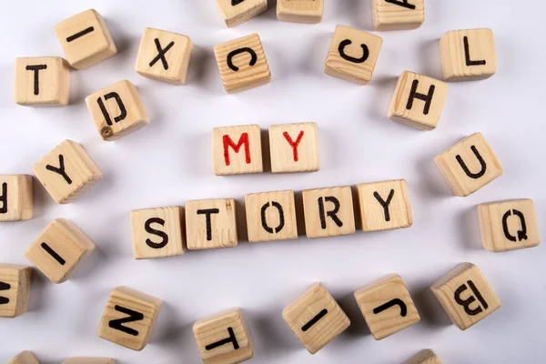 MY STORY. Word from wooden alphabet blocks on white background.