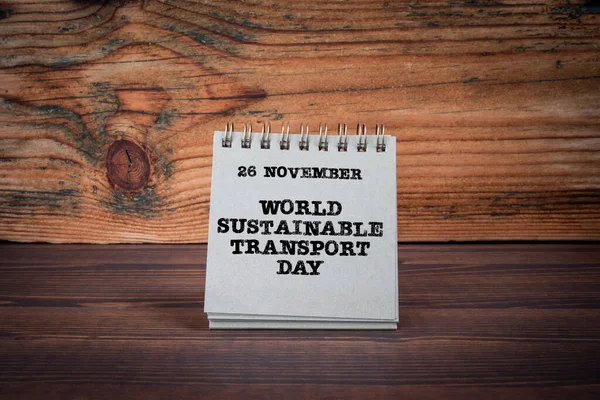 World Sustainable Transport Day 26 November. Planner on a wooden texture table.