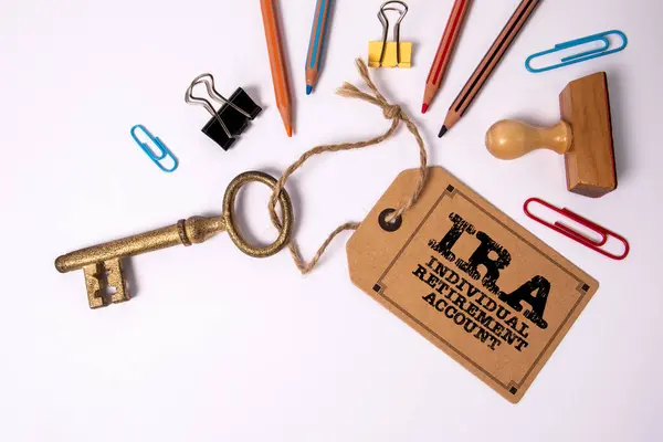 IRA Individual Retirement Account. Key with cardboard price tag on white background.