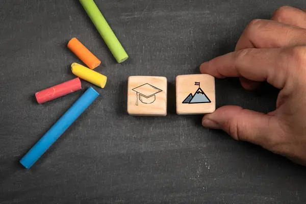 Education and Career Concept. Wooden blocks on a dark chalkboard background.
