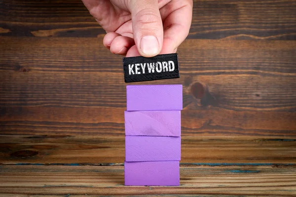 Keywords Research Concept. Purple blocks on wood texture background.