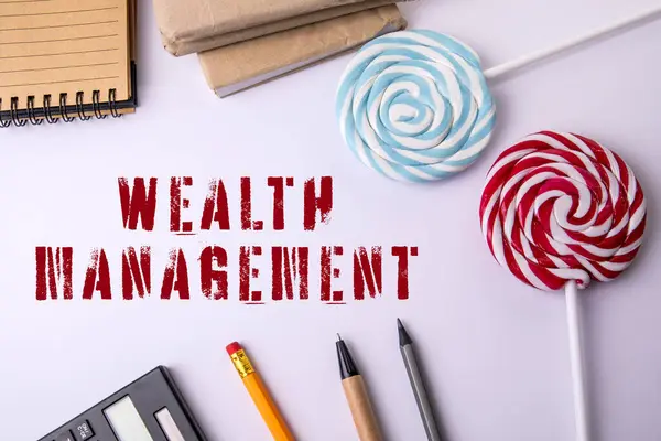 WEALTH MANAGEMENT. Office items on a white table.