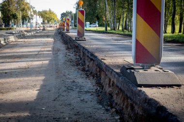 Yol yapılandırması sırasında öğütülmüş asfalt, sarı uyarı işaretleri.
