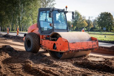 Road roller at construction site. Heavy machinery. clipart