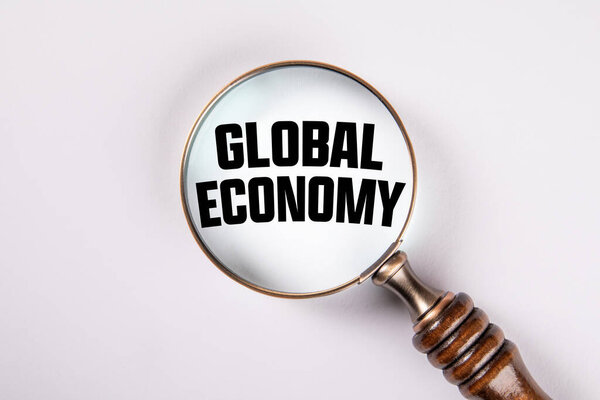 Magnifying Glass Focusing on GLOBAL ECONOMY Text Concept..
