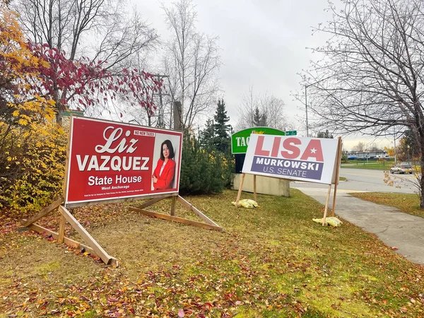 stock image OCT 11, 2022-ANCHORAGE, AK, US: Wooden frame campaign signs for Republican candidates Liz Vazquez, Lisa Murkowski for Alaska State House, US Senate candidates. Colorful fall foliage