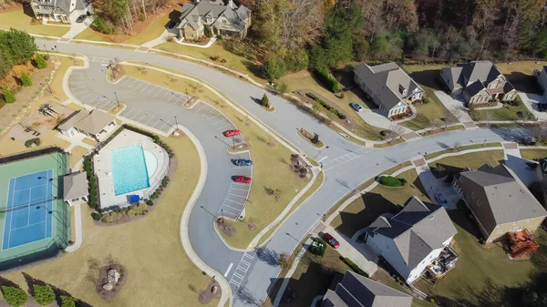 stock image Row of two story new development houses with recreational tennis court and swimming pool in upscale neighborhood suburbs Atlanta, Georgia, USA. Suburban residential area large backyard lush green