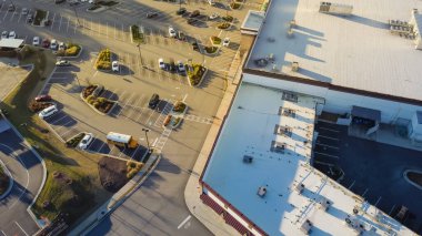 Large grocery store and strip mall with rooftop units for all in one HVAC solution in Flowery Branch, Georgia, USA. Aerial view heating and air conditioning system in commercial building supermarkets clipart