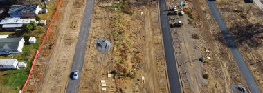 Panorama infrastructure onsite construction of concrete slab grade at mobile home park ready subsurface for installation of manufactured houses in Upstate New York. Aerial floating structural support