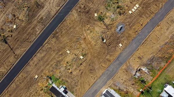 Infrastructure onsite construction of concrete slab on grade at mobile home park ready subsurface for installation of manufactured houses in Upstate New York. Aerial view floating structural support