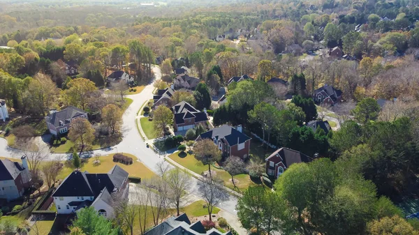 Subdivision urban sprawl row of two-story single-family house in leafy suburbs master planning residential neighborhood near Atlanta, Georgia, USA. Aerial view low-density upscale homes