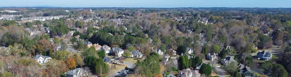 Panorama subdivision urban sprawl row of two-story single-family house in leafy suburbs master planning residential neighborhood in Atlanta, Georgia, USA. Aerial view low-density upscale homes