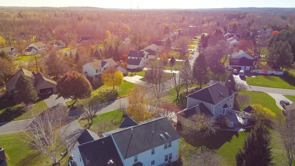 Aerial view master planned community with low density housing design, colorful autumn leaves in suburban residential neighborhood outside Rochester, New York, USA. Aerial view residential houses