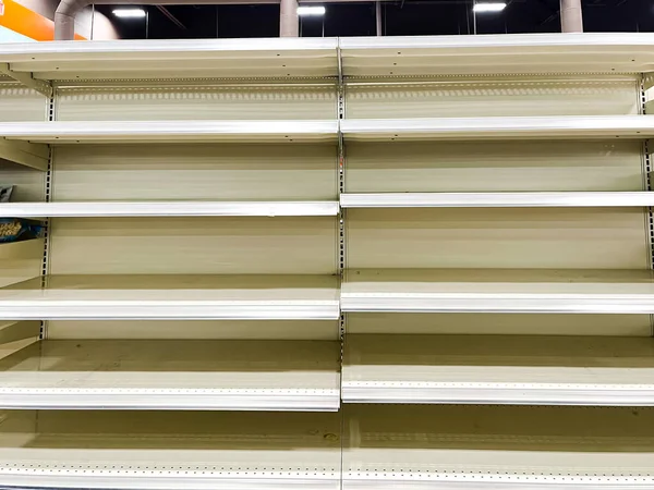 Empty shelves at grocery stores due to food shortage, pandemic, economic crisis or store closing near Dallas, Texas, America. Clear sold-out goods groceries at retailer super market