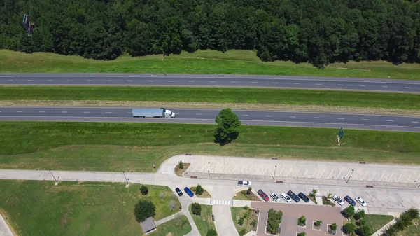Entrance to rest area along highway interstate 10 (I-10) in Greenwood, Louisianan, USA surrounding by green pine trees, well-trimmed yards and picnic area. Aerial modern freeway stop, transportation