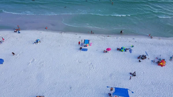 Renkli çadırlar, plaj şezlongları, yüzen, dinlenen, turkuaz suyla beyaz kumlu sahil şeridi boyunca yürüyen, Güney Walton plajı, Destin, Florida 'da kalabalık insanlar. Seyahat hedefi