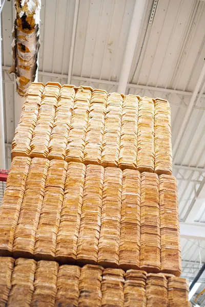 Looking up view tall full stack pallet of wooden cedar pickets up to ceiling of hardware home improvement store in Dallas, Texas, 1x6 unfinished in natural look with standard dog ear privacy top. USA