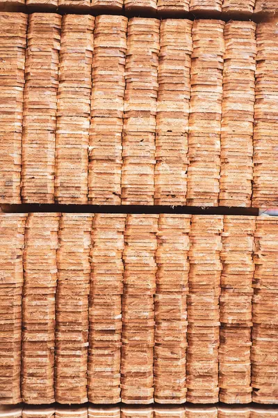 Full background large stack of wooden cedar pickets pallet with polyester strapping at hardware home improvement store in Dallas, Texas, 1x6 pickets unfinished natural look dog ear privacy top. USA
