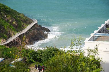 Masa sandalyesi seti olan modern çatı restoranı, dağların üzerine kereste kaldırımı, turist yürüyüşü, yüksek yaya yolu, uzak tatil adası Nha Trang. Vietnam