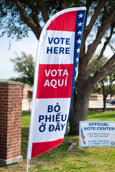 Vote flag banner and yard signs in multiple languages English, Spanish, Vietnamese, double-sided election decorations polling locations at elementary school, non-English-proficient groups in TX. USA