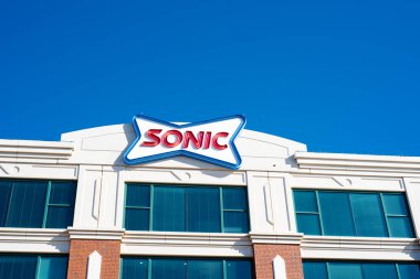 Oklahoma City, USA-MAR 10, 2024: Close-up Sonic logo trademark at headquarters corporate office in Bricktown, downtown Oklahoma, founded 1953, American drive-in fast-food chain owned by Inspire Brands clipart