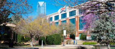 OKC, USA-MAR 10, 2024: Panorama view Sonic Corporate Headquarters office and tallest building in Oklahoma Devon Energy Center along Bricktown canal, drive-in fast-food chain owned by Inspire Brands clipart