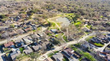 Lakeside residential neighborhood with bare trees wintertime suburbs Dallas Fort Worth metro complex, cul-de-sac dead-end street shapes keyhole, single family houses with swimming pools backyard. USA clipart