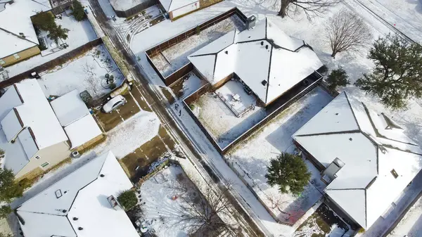 stock image Suburban houses and residential streets covered in heavy snow in suburbs Dallas, Dallas-Fort Worth metropolitan area impacts by severe weather, climate change, sunshine and melting snow, aerial. USA